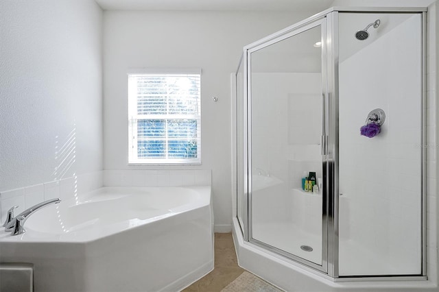 bathroom featuring tile patterned flooring, separate shower and tub, and plenty of natural light