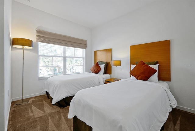 bedroom featuring dark colored carpet