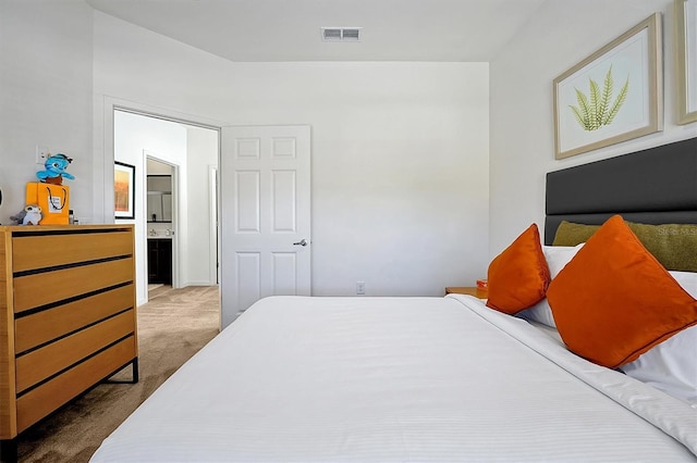 carpeted bedroom with ensuite bathroom