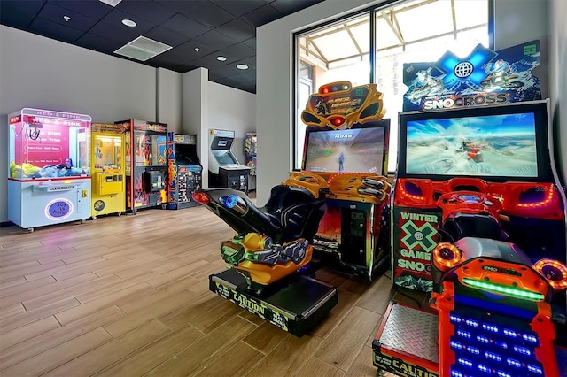 game room with a drop ceiling and wood-type flooring