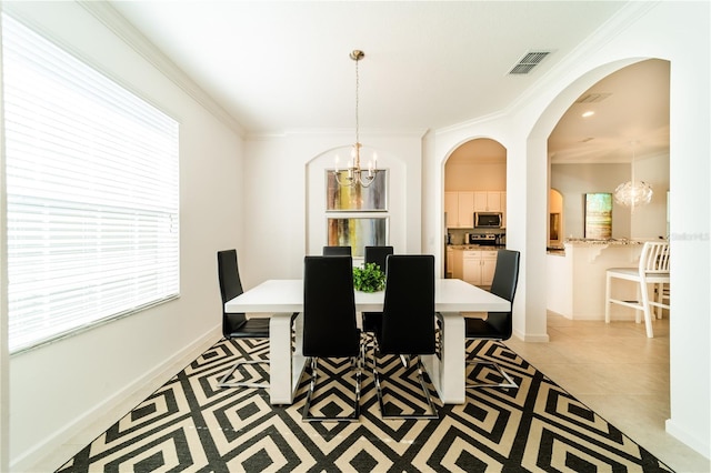 dining room featuring crown molding, light tile patterned floors, and an inviting chandelier