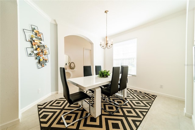 dining area with light tile patterned flooring, ornamental molding, and a chandelier