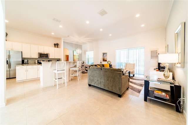 living room featuring light tile patterned floors and ornamental molding