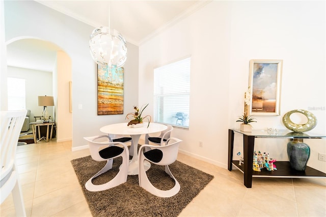 dining space with light tile patterned floors, an inviting chandelier, and crown molding