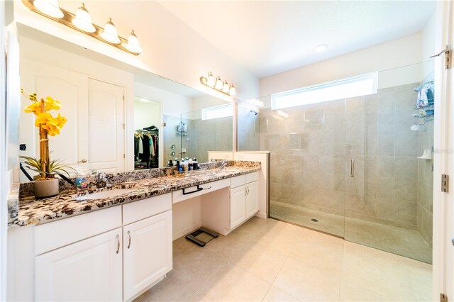 bathroom with vanity, tile patterned floors, and a shower with door