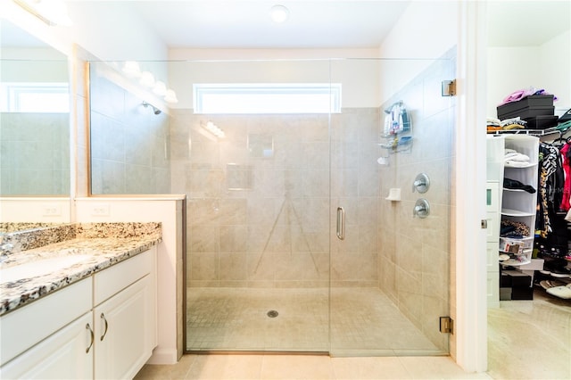 bathroom with vanity, tile patterned floors, and walk in shower