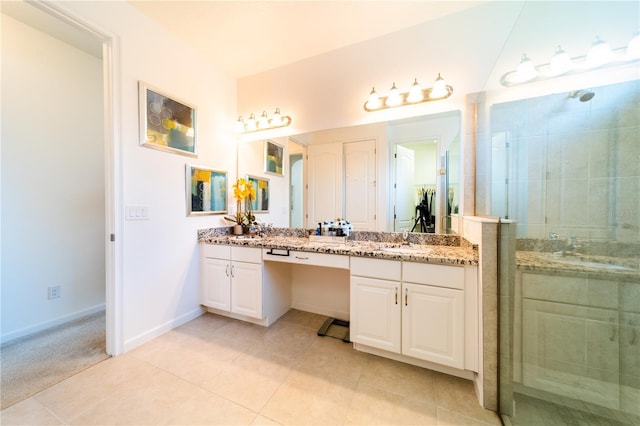 bathroom with tile patterned floors, a shower with door, and vanity