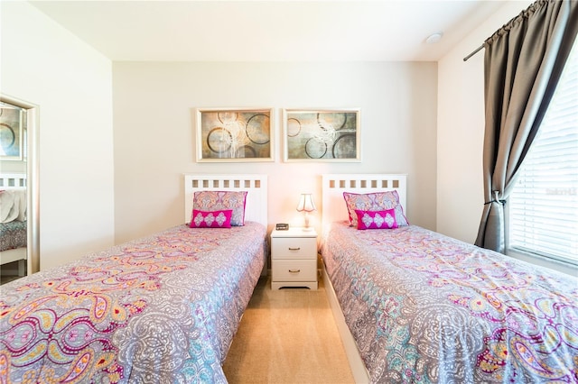 bedroom featuring light colored carpet