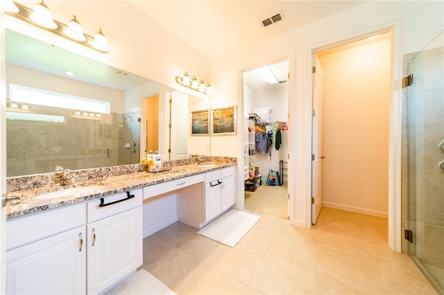 bathroom featuring tile patterned flooring, vanity, and an enclosed shower