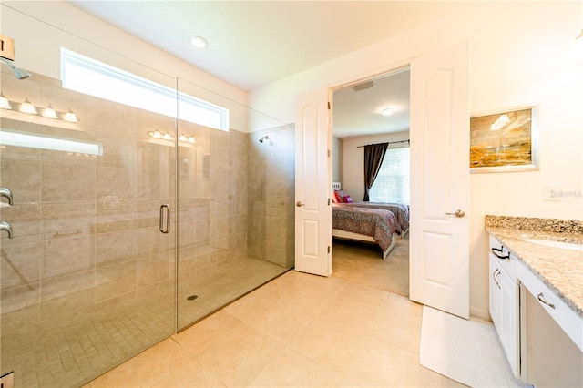 bathroom featuring tile patterned floors, vanity, and an enclosed shower