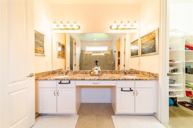 bathroom featuring tile patterned floors, vanity, and walk in shower