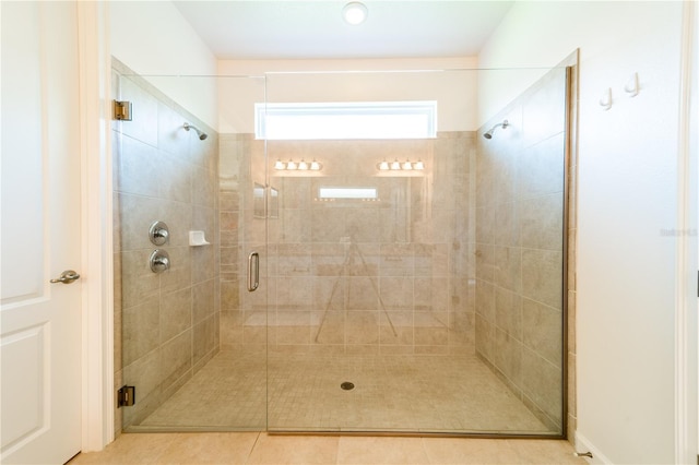 bathroom with tile patterned floors and walk in shower