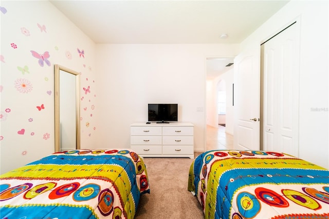 carpeted bedroom featuring a closet