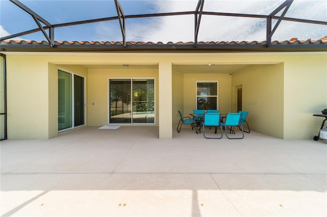 view of patio featuring a lanai