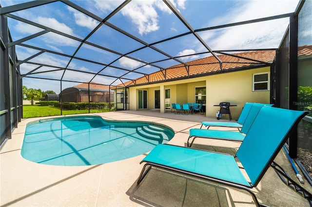 view of swimming pool featuring a patio area and a lanai