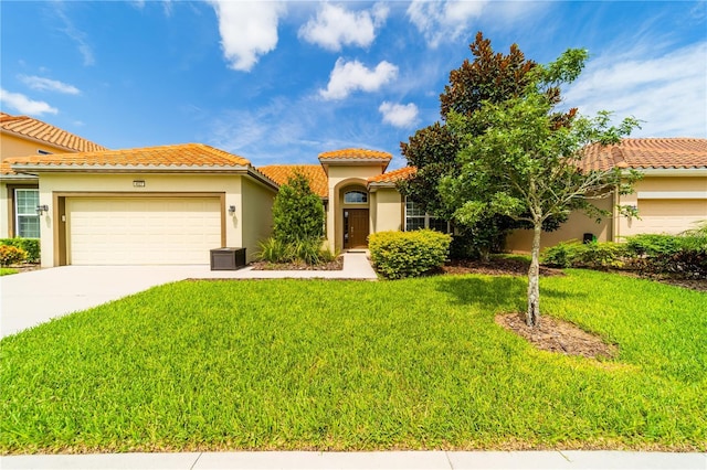 mediterranean / spanish house featuring a garage and a front lawn