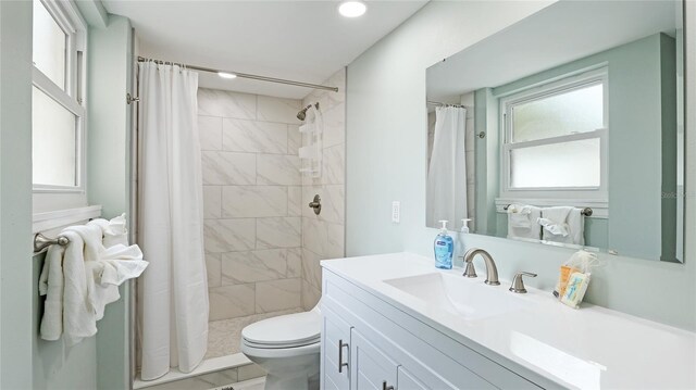 bathroom with vanity, a wealth of natural light, a shower with shower curtain, and toilet