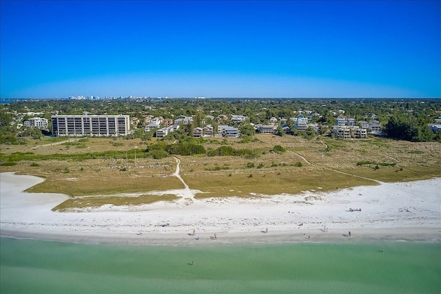 aerial view with a water view and a beach view