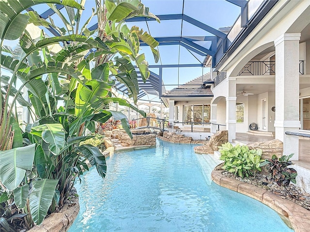 view of swimming pool with glass enclosure