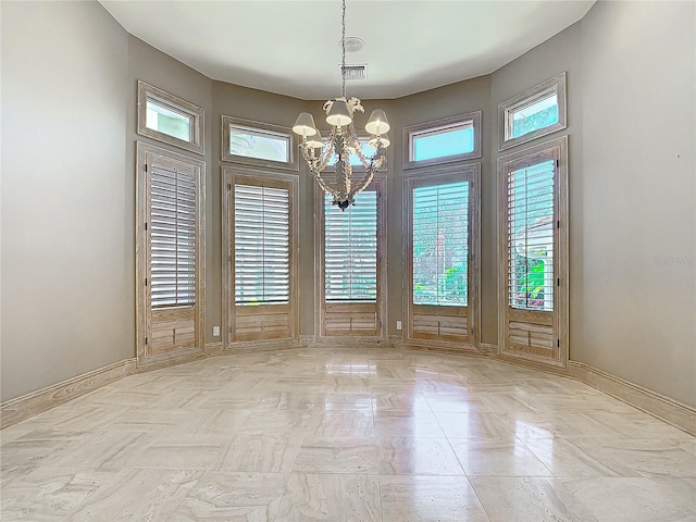 unfurnished dining area featuring a chandelier