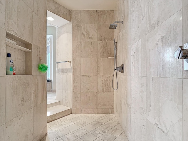 bathroom with tiled shower