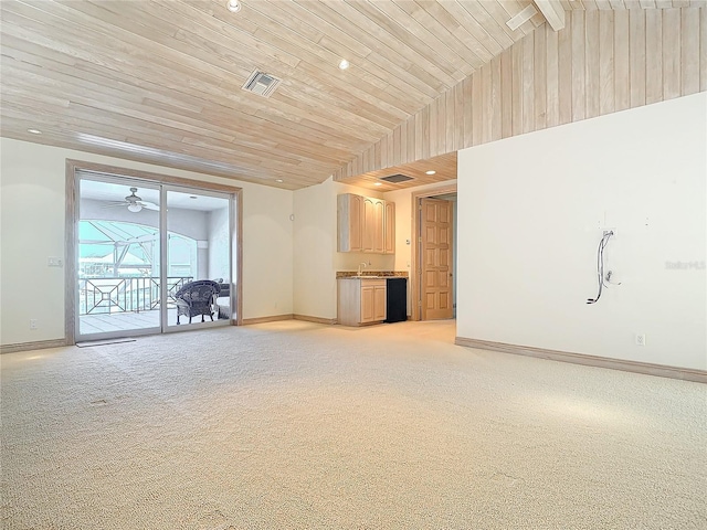 unfurnished living room with light carpet, ceiling fan, wood ceiling, and vaulted ceiling