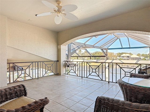 view of patio / terrace featuring ceiling fan and a water view