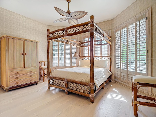 bedroom with multiple windows, light wood-type flooring, and ceiling fan