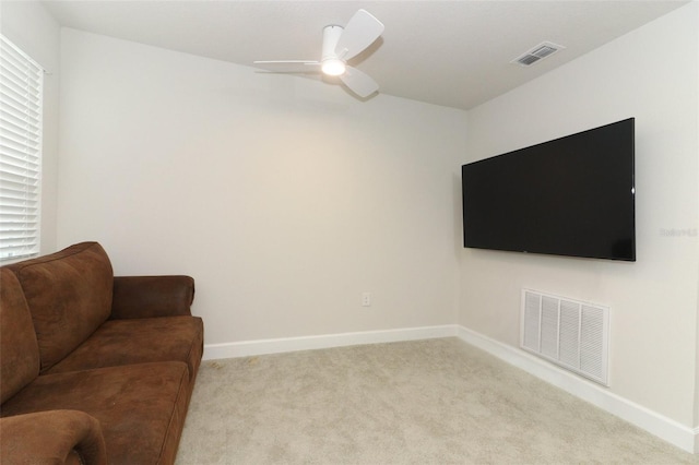 carpeted living room featuring ceiling fan