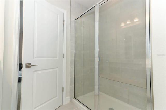 bathroom with tile patterned floors and an enclosed shower