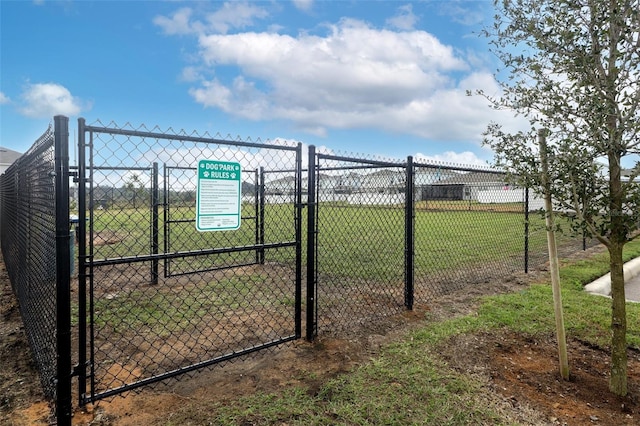 view of gate featuring a lawn