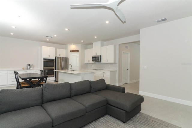 tiled living room with ceiling fan