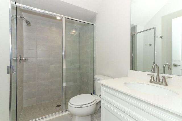 bathroom with vanity, toilet, and an enclosed shower