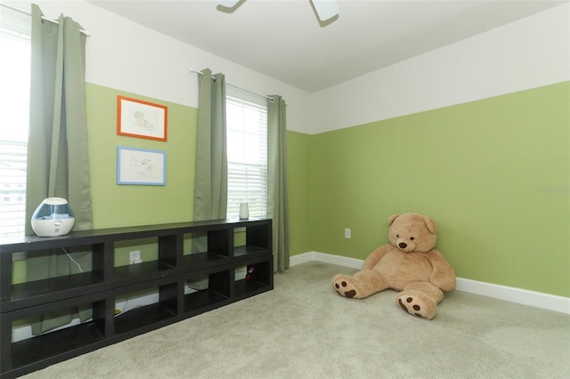 recreation room featuring light colored carpet and ceiling fan