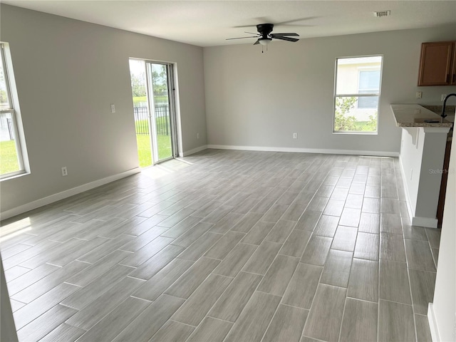 unfurnished living room featuring ceiling fan