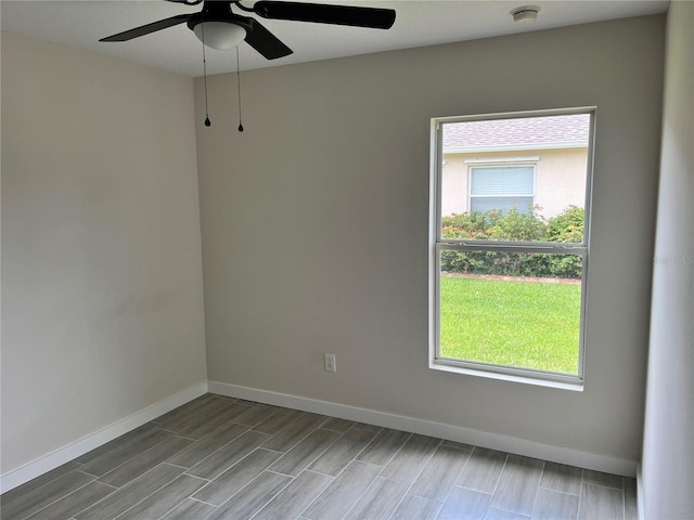 spare room featuring plenty of natural light and ceiling fan