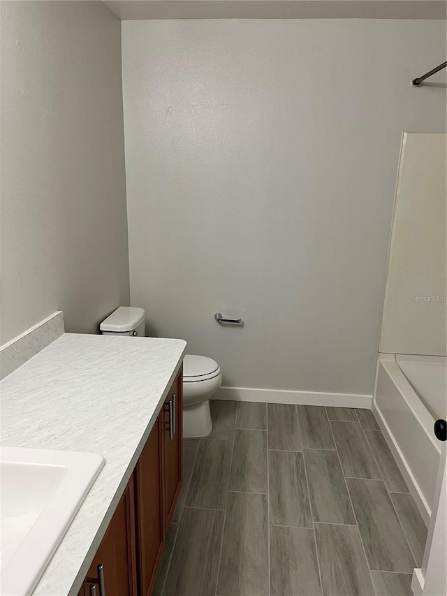 full bathroom featuring shower / washtub combination, vanity, and toilet