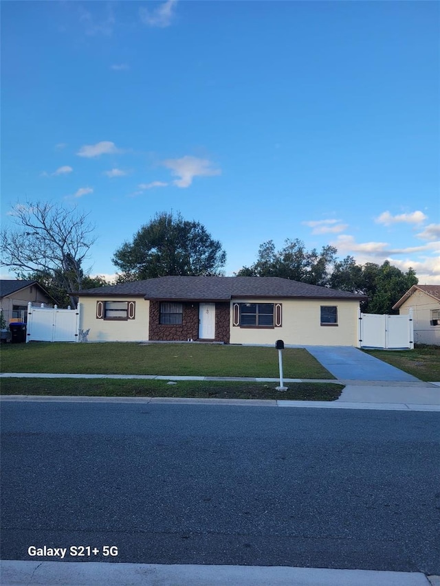 ranch-style house with a front lawn