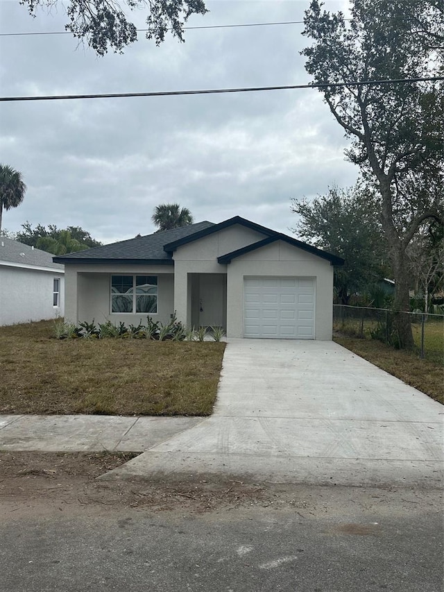 ranch-style home featuring a front lawn and a garage