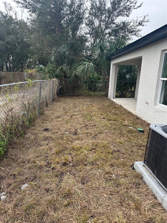 view of yard with central AC unit