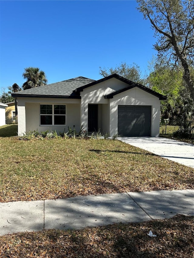 view of front of home with a garage and a front lawn