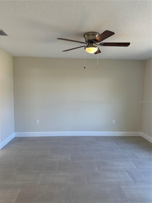 spare room featuring a textured ceiling and ceiling fan