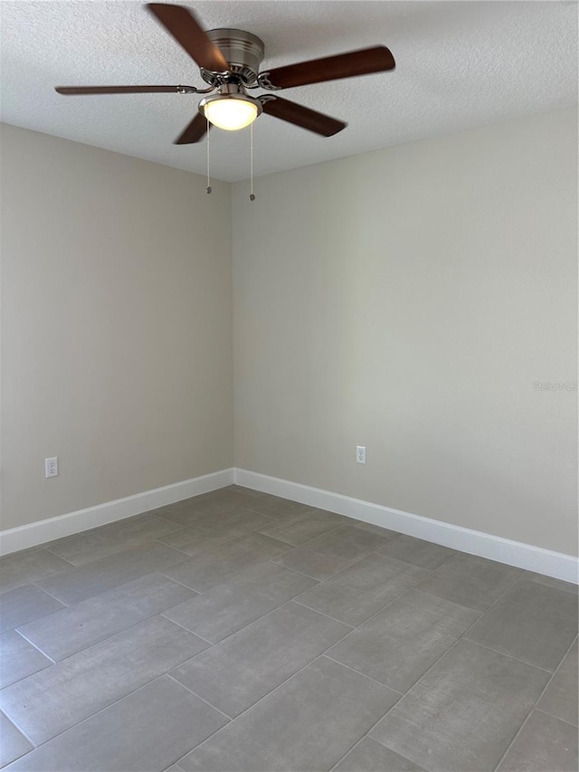 unfurnished room with a textured ceiling