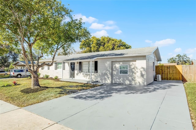 ranch-style house with central AC and a front yard