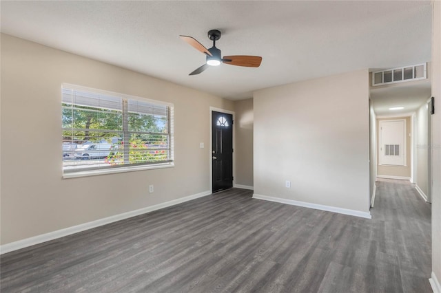 unfurnished room with ceiling fan and dark hardwood / wood-style floors