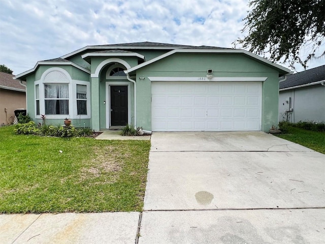 ranch-style home with a front lawn and a garage