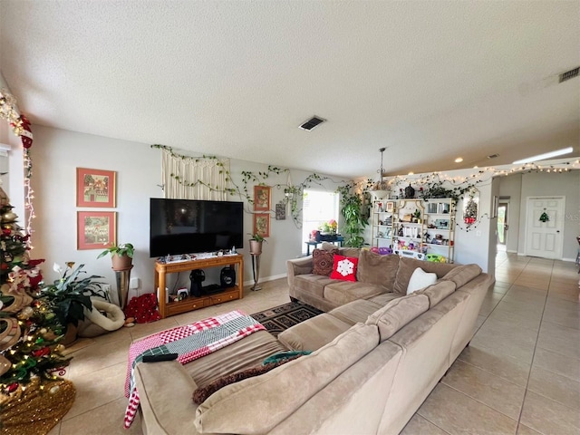 living room with light tile patterned floors and a textured ceiling