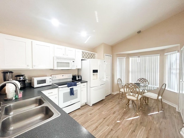 kitchen featuring white appliances, sink, vaulted ceiling, light wood-type flooring, and white cabinetry