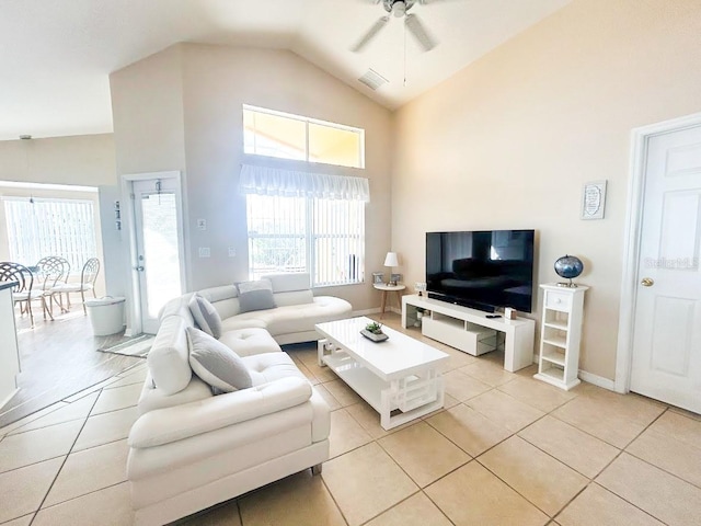 tiled living room featuring ceiling fan and vaulted ceiling