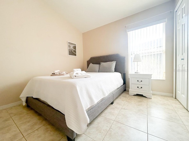 tiled bedroom with lofted ceiling